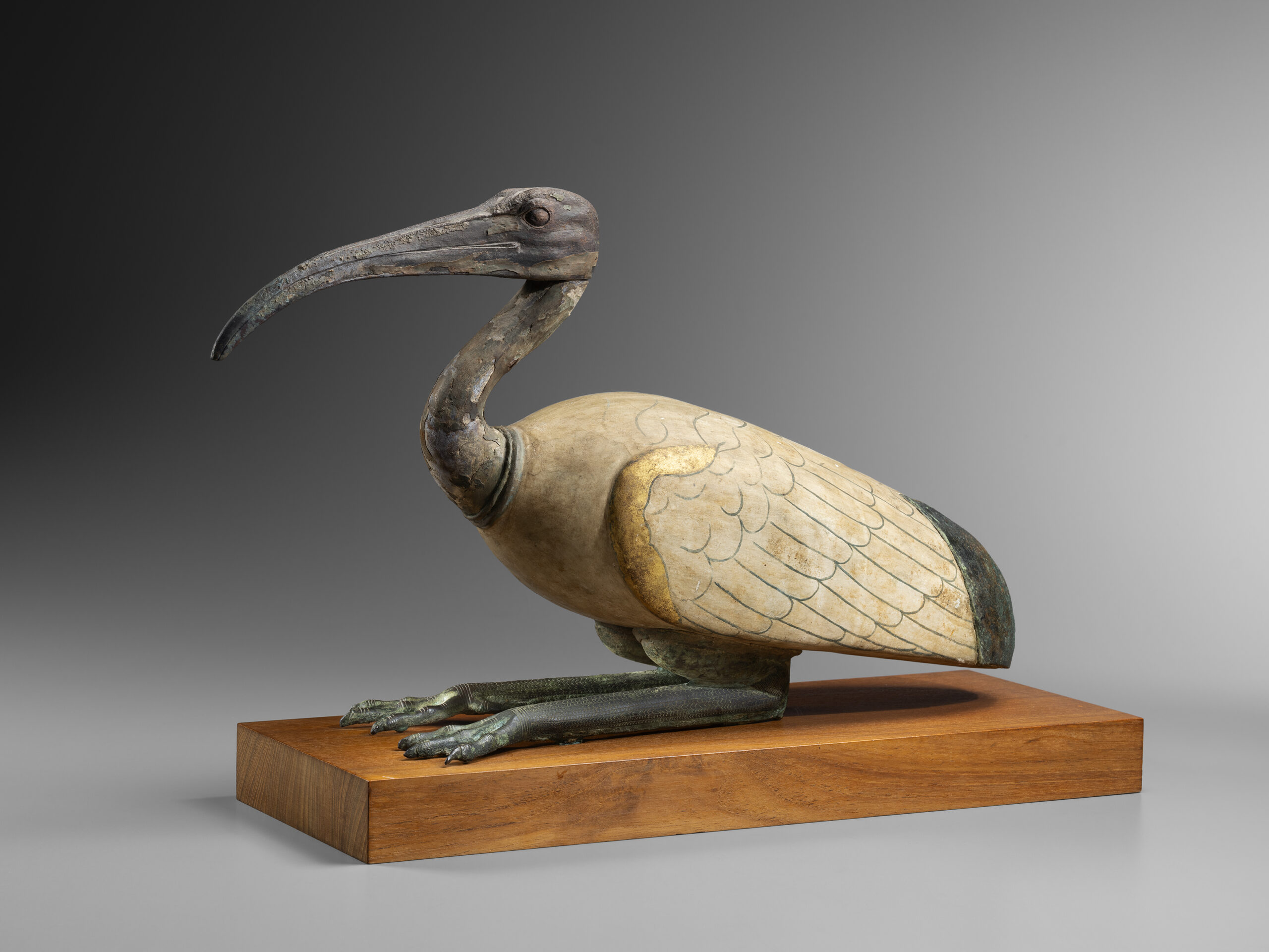 AN EGYPTIAN WOOD AND BRONZE IBIS AN EGYPTIAN WOOD AND BRONZE IBIS