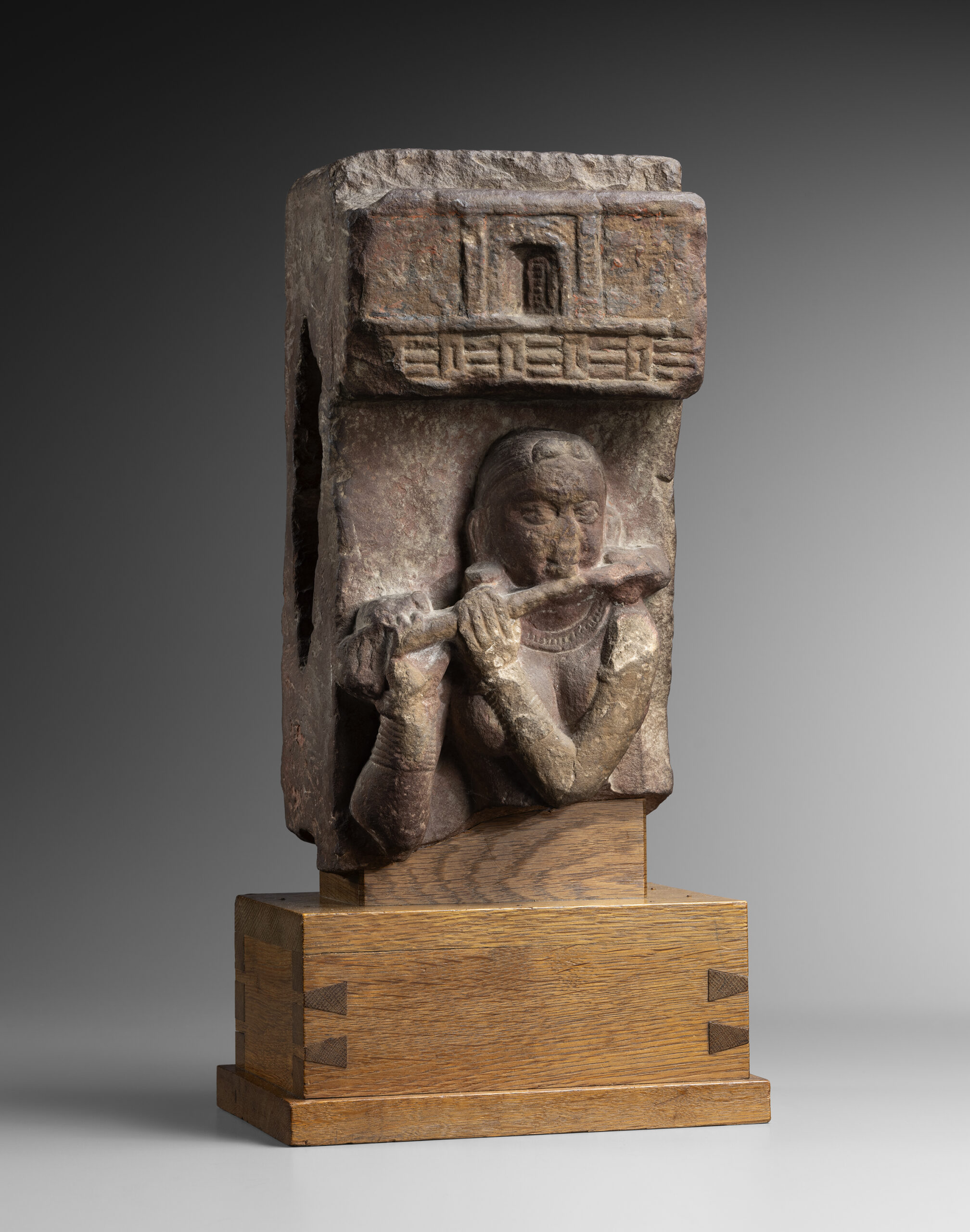 STELE FRAGMENT DEPICTING A FLUTE PLAYER