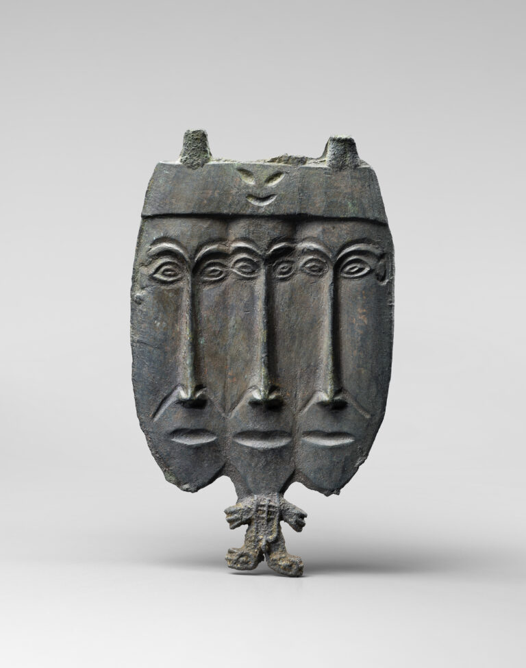 ANTHROPOMORPHIC BRONZE PLAQUE WITH THREE-HEADED DEITY