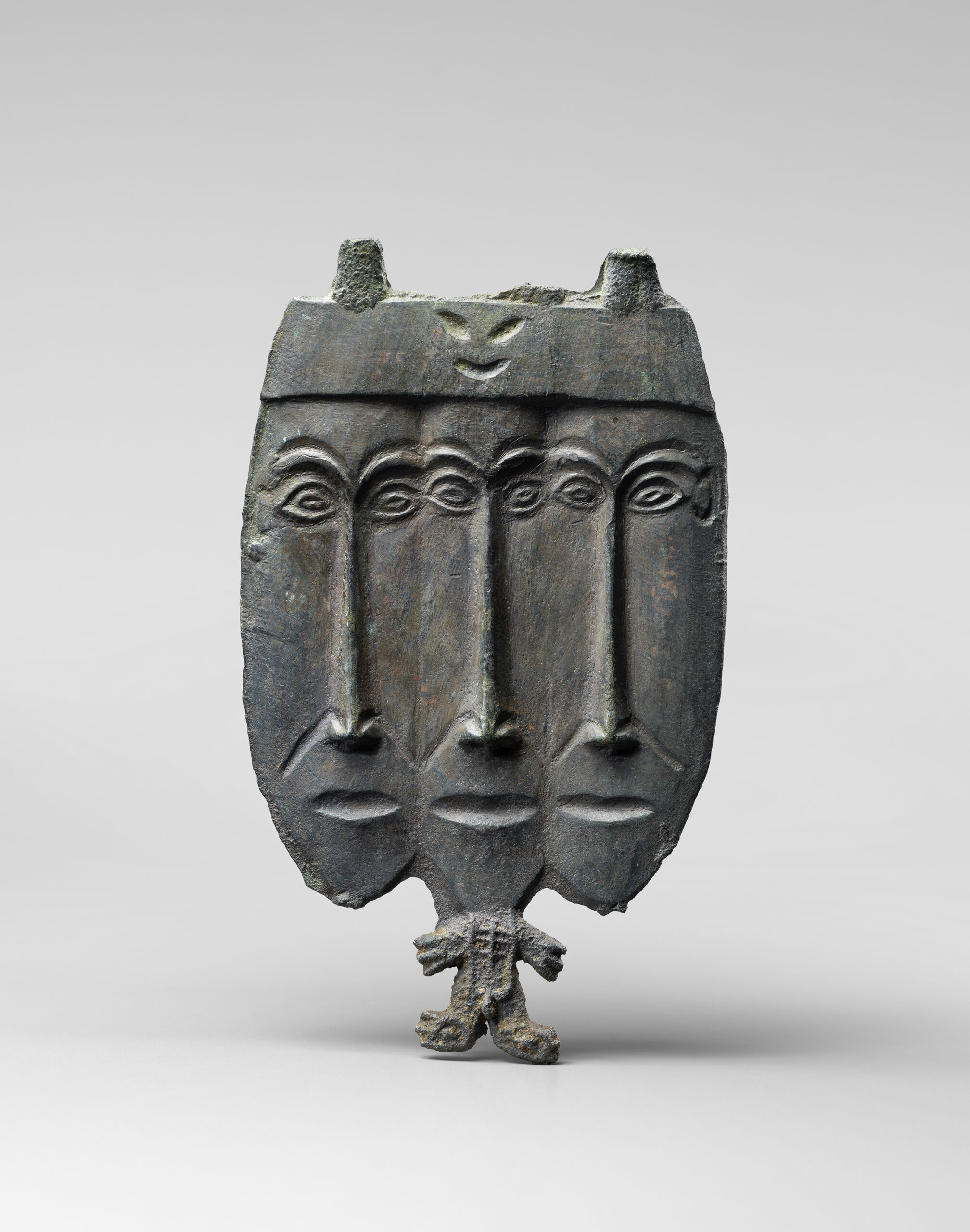 ANTHROPOMORPHIC BRONZE PLAQUE WITH THREE-HEADED DEITY
